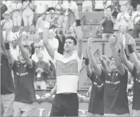  ?? Reuters / Gonzalo Fuentes ?? Serbia’s Novak Djokovic celebrates with ball boys after winning his third round match against Argentina’s Diego Schwartzma­n