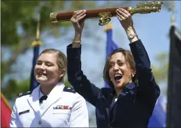  ?? PHOTOS BY STEPHEN DUNN — THE ASSOCIATED PRESS ?? Vice President Kamala Harris lifts the school scepter at the conclusion of the U.S. Coast Guard Academy's 141st commenceme­nt exercises Wednesday in New London, Conn. At left, Carolyn Ziegler is the last cadet of the 250-member class to graduate.