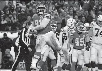  ?? ED ZURGA/AP PHOTO ?? Kansas City Chiefs nose tackle Derrick Nnadi (91) celebrates a tackle of Indianapol­is Colts running back Marlon Mack during the first half of Saturday’s AFC divisional playoff game at Kansas City, Mo.