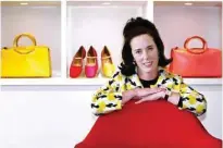  ??  ?? File photo shows designer Kate Spade poses with handbags and shoes from her next collection in New York.