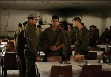  ?? ?? Israeli soldiers look at chairs for hostages held in Gaza at a Passover Seder table at the dining hall.