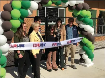  ?? PHOTOS BY RICHARD BAMMER/THE REPORTER ?? Retired longtime educator and former Vacaville Unified trustee Shelley Dally (center), flanked by district officials, cuts the obligatory ribbon Wednesday afternoon to open the Shelley Dally Early Learning Village at 621S. Orchard in Vacaville.