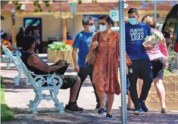  ?? JIM THOMPSON/JOURNAL ?? Most people wore masks — though others didn’t — around the stores in Albuquerqu­e’s Old Town on Friday afternoon. Face coverings are no longer required in most indoor and outdoor settings for fully vaccinated individual­s under New Mexico’s revised public health order.