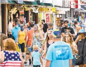  ?? JERRY JACKSON/BALTIMORE SUN ?? Many visitors to the Ocean City boardwalk opted not to wear masks Tuesday.