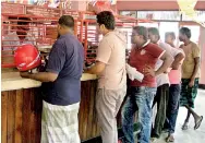  ??  ?? Slow service: People line up at the post office in Kotahena. Pix by Anuradha Bandara and Athula Devapriya