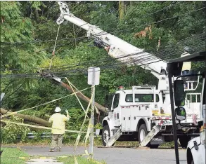  ?? Matthew Brown / Hearst Connecticu­t Media ?? A utility crew works to erect a downed pole on Taylor Street on August 7, 2020 in Stamford. Many out of state crews were brought in to assist Eversource in restoring power to the region and help with clean up of storm debris left in the wake of Tropical Storm Isaias.