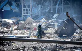  ?? The Associated Press ?? An Ukrainian firefighte­r works near a destroyed building on the outskirts of Odesa, Ukraine, on Tuesday. The Ukrainian military said Russian forces fired seven missiles a day earlier from the air at the crucial Black Sea port of Odesa, hitting a shopping center and a warehouse.