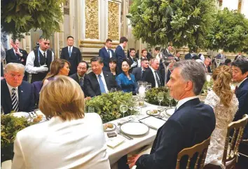  ?? AFP ?? Argentina’s President Mauricio Macri, US President Donald Trump, China’s President Xi Jinping, Russian President Vladimir Putin and South Korea’s President Moon Jae-in, along with other G20 leaders and their spouses attend a banquet after a gala in Buenos Aires yesterday on the sidelines of the G20 Summit.