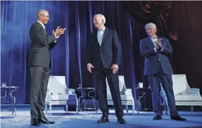  ?? BRENDAN SMIALOWSKI/AFP VIA GETTY IMAGES ?? The rare showing of three Democratic presidents presented a united front to help Biden bring together a Democratic coalition that’s shown signs of splinterin­g.