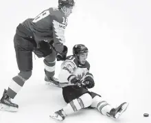  ?? PETR JOSEK, THE ASSOCIATED PRESS ?? Latvia’s Rodrigo Abols, left, trips up Canada’s Jean-Gabriel Pageau as they battle for the puck during Group B action in Herning, Denmark, on Monday.