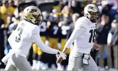  ?? CHARLIE NEIBERGALL — THE ASSOCIATED PRESS ?? Purdue quarterbac­k Aidan O’Connell (16) celebrates with wide receiver David Bell (3) after scoring on a six-yard touchdown run on Saturday in Iowa City, Iowa.