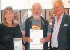  ??  ?? Jill and Gary Buswell from The Lime Kilns in Burbage received a certificat­e from Camra chief executive Tim Page, right, at the tenth Hinckley Beer Festival to mark their pub’s inclusion in the 2018 Good Beer Guide. Picture: Alan Cooke