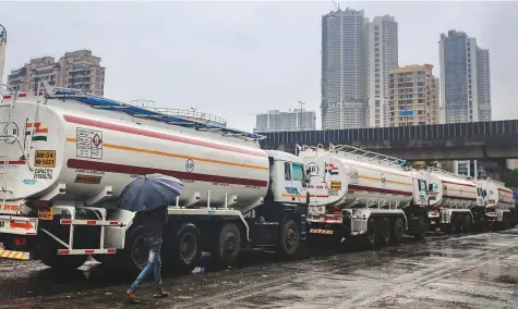  ?? Bloomberg ?? Fuel tankers parked in the Mahul area of Mumbai. With the general election usually held in phases and typically lasting a month, oil retailers would have to bear the cost of price-freezes if crude continues to climb.