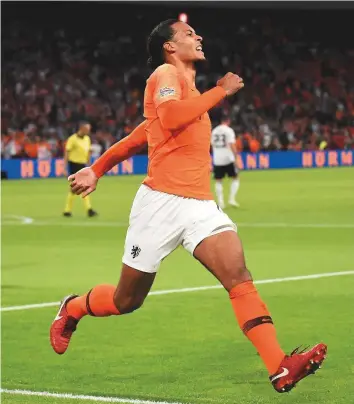  ?? AFP ?? Netherland­s’ defender Virgil van Dijk celebrates after scoring the opening goal against Germany during the Uefa Nations League match on Saturday. The Netherland­s won 3-0.