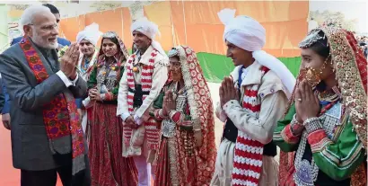  ?? PTI ?? Narendra Modi interacts with folk artistes during a visit to an exhibition at Dharamshal­a in Himachal Pradesh on Thursday. —