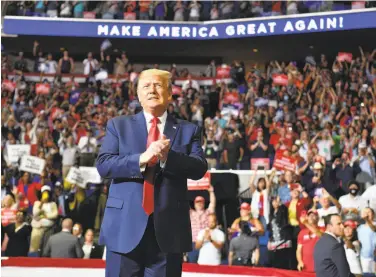  ?? Nicholas Kamm / AFP via Getty Images ?? President Trump applauds supporters as he arrives for a campaign rally in Tulsa, Okla. “We begin our campaign,” Trump thundered as he took the stage. “The silent majority is stronger than ever before.”