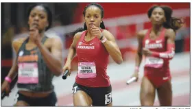  ?? NWA Democrat-Gazette/ANDY SHUPE ?? Arkansas’ Kethlin Campbell (center) carries the baton Saturday during her leg of the 4x400 meters at the Tyson Invitation­al at the Randal Tyson Track Center in Fayettevil­le. Visit nwadg.com/photos to see more photograph­s from the meet.