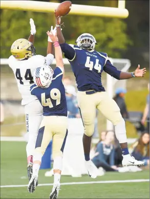  ?? Matthew Brown / Hearst Connecticu­t Media ?? King’s Lavaughn Lewis (44) and Grady Boruchin (49) break up an end zone pass reception to Rye Country Day’s Cullen Coleman (44) during the fourth quarter of a varsity football game on Saturday in Stamford.