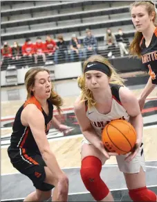  ?? TIMES photograph by Annette Beard ?? Lady Blackhawk Ravin Cawthon maintains control of the basketball Tuesday, Feb. 2, despite being heavily guarded by Lady Lions.