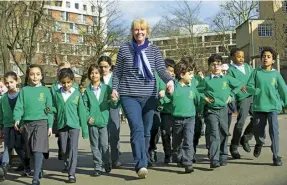  ??  ?? Below The Daily Mile founder Elaine Wyllie, with children at Hallfield primary school in London