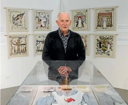  ??  ?? Douglas Browne stands in front of his mother Edith’s old Voluntary Aid Detachment (VAD) nurse uniform at the Mount Felix Tapestry exhibition.