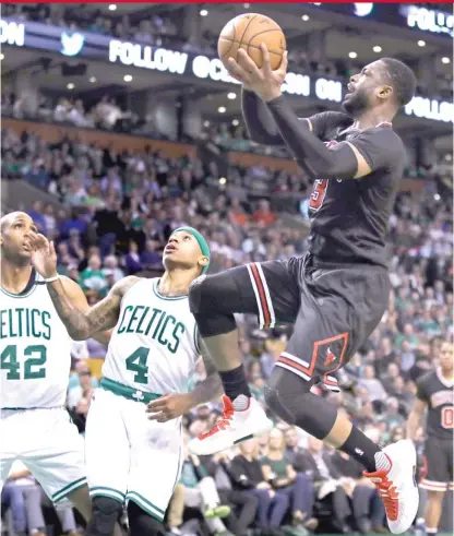  ??  ?? Bulls guard Dwyane Wade, who had 26 points, drives to the basket against Celtics guard Isaiah Thomas in the second quarter. | AP