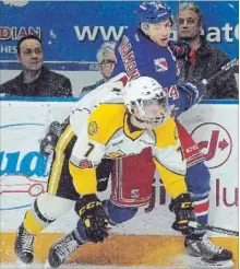  ?? DAVID BEBEE WATERLOO REGION RECORD ?? Sarnia Sting defender Nick Grima crashes to the ice after bouncing off Kitchener Rangers forward Connor Bunnaman on Tuesday at the Aud.