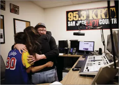  ?? PHOTOS BY DAI SUGANO — STAFF PHOTOGRAPH­ER ?? KRTY morning show host Gary Scott Thomas hugs his wife, Heather Thomas, and their sons Luke, 12, and Jackson, 6, after his show in the KRTY studio in San Jose on Friday. KRTY ceased broadcasti­ng on FM on Friday and switched only to KRTY.com.