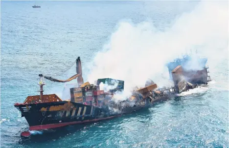  ?? SRI LANKA AIR FORCE ?? A bigger disaster possible: The MV X-Press Pearl container ship is shown Wednesday at a port in Colombo, Sri Lanka. Salvage experts failed to tow the fire-stricken vessel carrying chemicals out to sea and it started to sink off Sri Lanka’s main port. Environmen­talist Ajantha Perera said the incident could cause “a terrible environmen­tal disaster.”