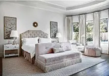  ??  ?? The master bedroom is outfitted in soft pink, and panels of hand-painted chinoiseri­e are framed and hung over white nightstand­s.