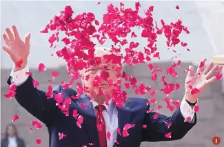  ?? PHOTO: AP/PTI ?? 1. US President Donald Trump offers floral respects at Raj Ghat