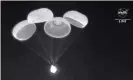  ?? Photograph: AP ?? Parachutes are deployed from the SpaceX Dragon capsule