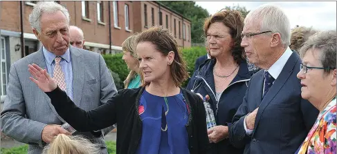  ??  ?? Sorcha Malone, Housing Officer with North and East Housing Associatio­n explains her project to ‘Pride of Place’ judges William Beattie and Donal Connolly during their visit to Moneymore. Below, Part of the large community attendance.