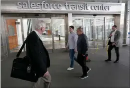  ??  ?? Pedestrian­s pass by the Salesforce Transit Center in San Francisco on Thursday.