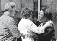  ?? AP/BRENNAN LINSLEY ?? Sherry Delaney (right) hugs Arlene Holmes on Monday as she and Robert Holmes (left) leave the courthouse in Centennial, Colo., after attending hearings in the case against their son, Aurora theater-shooting suspect James Holmes.