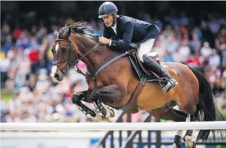  ?? JEFF McINTOSH/THE CANADIAN PRESS ?? Richard Spooner, riding Cristallo, competes in the Nexen Cup Derby during the National at Spruce Meadows on Sunday. The American rider completed a rare zero-fault performanc­e, only the fourth ever in the event’s history.