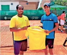  ??  ?? Sharmal Dissanayak­e presenting the national jersey to debutant Thehan Wijemanne prior to the Davis Cup playoff in Paraguay