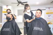  ?? ?? Augustine (left) and Lau getting their heads shaved after the launch of GoBald 2024 in Kuching.