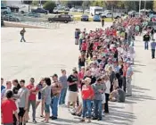  ?? PHOTOS BY STEPHEN M. DOWELL/STAFF PHOTOGRAPH­ER ?? Above, hundreds of supporters line up for a Donald Trump rally Tuesday at Orlando Sanford Internatio­nal Airport in Sanford. At right, Trump waves to his cheering supporters as he arrives for the campaign event. He vowed to bring space and technology...