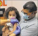  ?? Las Vegas Review-journal ?? Bizuayehu Tesfaye
Roberto Lopez holds daughter Jasmin Moreno, 4, as Victoria Hodge, licensed practical nurse, left, vaccinates her.