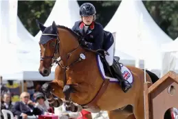  ??  ?? In the saddle: Young Katie at a showjumpin­g competitio­n