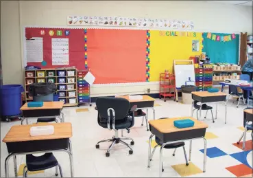  ?? Saul Flores / Hearst Connecticu­t Media ?? Sara Calechnan gets her classroom ready for students to begin instructio­n on Wednesday.