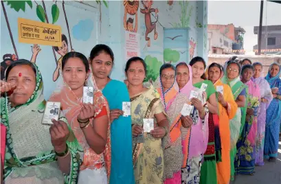  ?? PTI ?? Women voters showing their identity cards to cast their votes for Zilla Parishad Panchayat Samiti election at Koparde Village in Karad, Maharashtr­a, on Tuesday. —