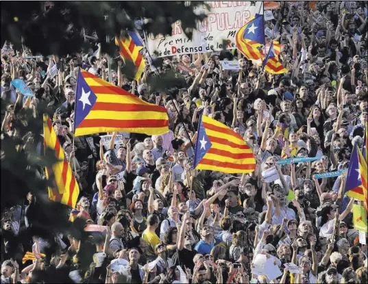  ?? Emilio Morenatti The Associated Press ?? Thousands of protesters wave Catalonia independen­ce flags as they take part in a rally Saturday in Barcelona, Spain.