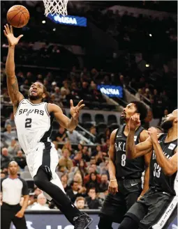  ?? 3FVUFST ?? 4"/ "/50/*0 41634 forward Kawhi Leonard (2) shoots the ball past Brooklyn Nets guards Spencer Dinwiddie (8) and Allen Crabbe (33) as the Spurs top the Nets 109-97 at AT&T Center.