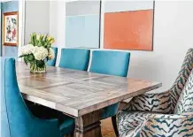  ?? ?? Deep turquoise in chairs and art in the dining room mimic the colorful wallpaper in the nearby entry.