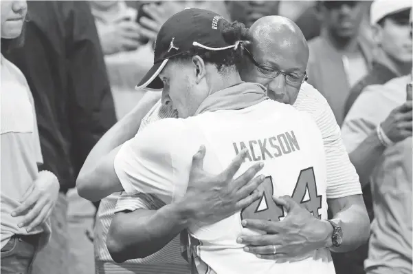  ?? KEVIN C. COX, GETTY IMAGES ?? Justin Jackson celebrates a North Carolina win against Kentucky with his father, Lloyd, who says he’s “totally different than LaVar Ball.”