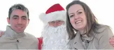  ??  ?? Christmas spirit Pictured with Santa are Gary Liddell and Lynne Russell from Glasgow who were in the area visiting family in Rattray