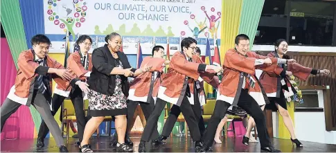  ?? CONTIRBUTE­D PHOTOS ?? USAID Acting Mission Director Rebecca Robinson joins the Japanese delegation in performing a traditiona­l dance in celebratio­n of their second-place finish in the dance competitio­n.