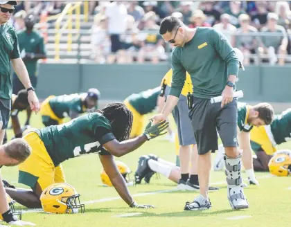  ?? BENNY SIEU/USA TODAY SPORTS ?? New Packers head coach Matt Lafleur greets players during the first day of training camp at Ray Nitschke Field in Green Bay, Wis. All eyes will be on Lafleur’s relationsh­ip with QB Aaron Rodgers, who had a toxic relationsh­ip with the team’s previous head coach.